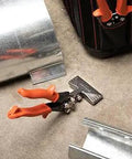 3 Inch Offset Handle Hand Seamer For Sheet Metal WS4N with ergonomic non-slip grip on a workshop floor with metal sheets.