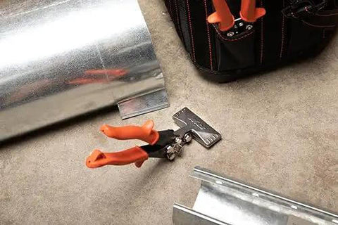 3 Inch Offset Handle Hand Seamer For Sheet Metal WS4N with ergonomic non-slip grip on a workshop floor with metal sheets.