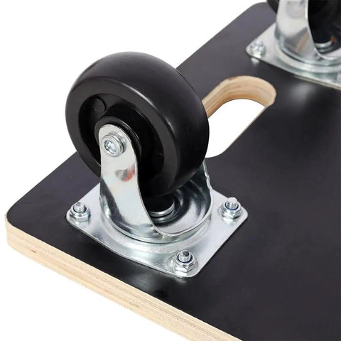Close-up of the smooth swivel caster on a heavy duty furniture dolly, showing the sturdy plywood platform.