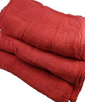 Stack of red industrial grade shop towels 100 percent cotton heavy duty garage cleaning and spill cleanup for auto shops and workshops.