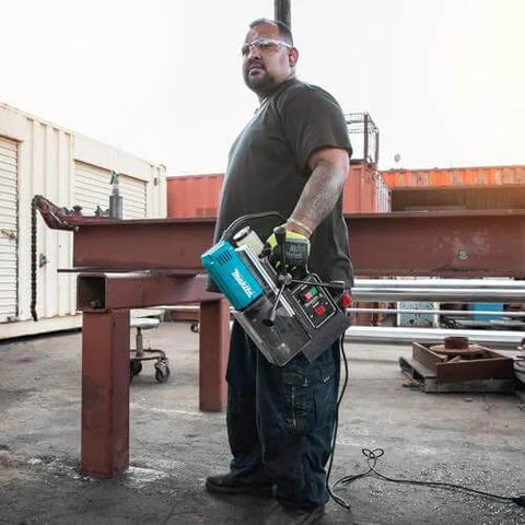 Front view of Makita HB350 magnetic drill, blue body, held by worker on steel beam