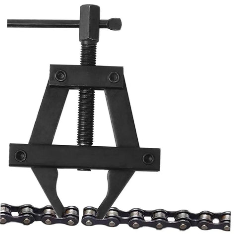 Heavy Duty Motorcycle Chain Tensioner Tool That Makes Bike Wrenching A Breeze Straight Up Solid Steel Chain Adjuster Kit close-up on steel tool against chain links.
