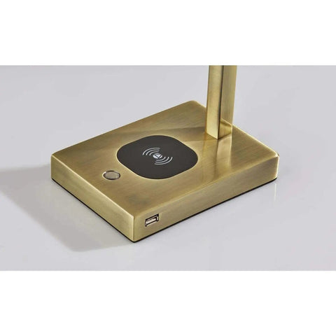 Base of Aidan LED Wireless Charging Desk Lamp With Built In 5W Qi Pad in brass finish, showing USB port and Qi charging symbol.