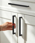 Person using 5 Pack 160mm Edge Black Hidden Drawer Cabinet Handle Aluminum Alloy Finger Edge Pull Concealed Back Mount Dresser Hardware For Kitchen And Bathroom, Rust Resistant, Waterproof, Smooth Sliding, Easy Install on white cabinets.