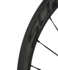 Close-up of Carbon Fiber Road Bike Wheelset 700c Clincher With 38mm Depth And 23mm Wide Rim showing Toray T700 material and spokes.
