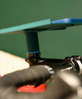 Close-up of indoor bike trainer tray with adjustable handlebar mount in sleek ABS design for phones and snacks