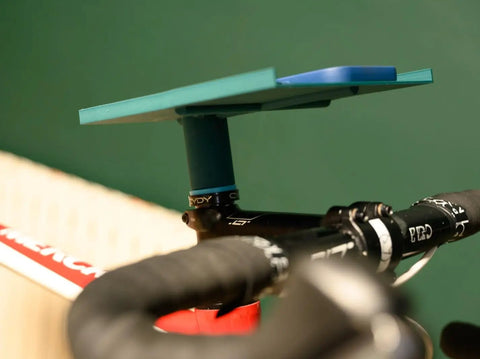 Close-up of indoor bike trainer tray with adjustable handlebar mount in sleek ABS design for phones and snacks