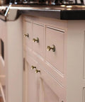 Kitchen cabinets with Antique Brass Cabinet Knobs With Gear Like Backplate Six Pack, Vintage Round Cup Design, Rustic Patina Finish installed.