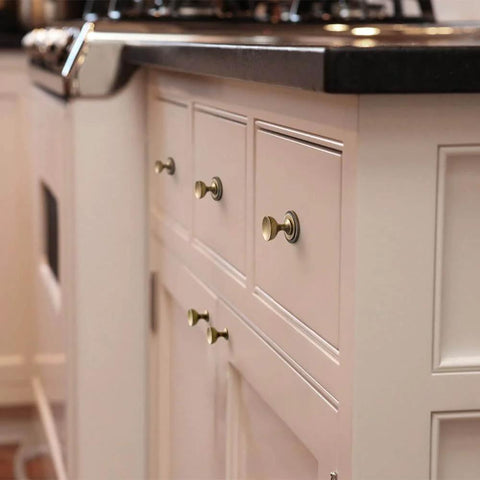 Kitchen cabinets with Antique Brass Cabinet Knobs With Gear Like Backplate Six Pack, Vintage Round Cup Design, Rustic Patina Finish installed.