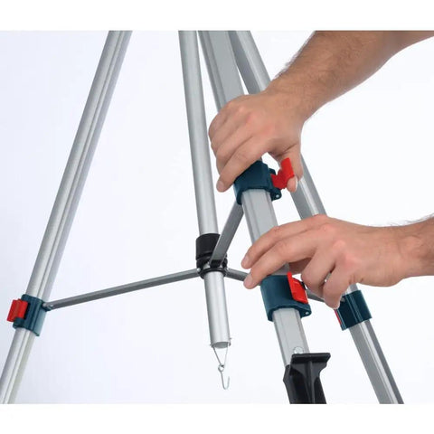 Hands adjusting the Lightweight Heavy Duty Aluminum Elevator Tripod With Precise Centimeter And Millimeter And Feet And Inches Graduations