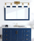 Cool Five Light Brushed Brass Vanity Light Fixture With Clear Glass Shades above a blue bathroom cabinet.