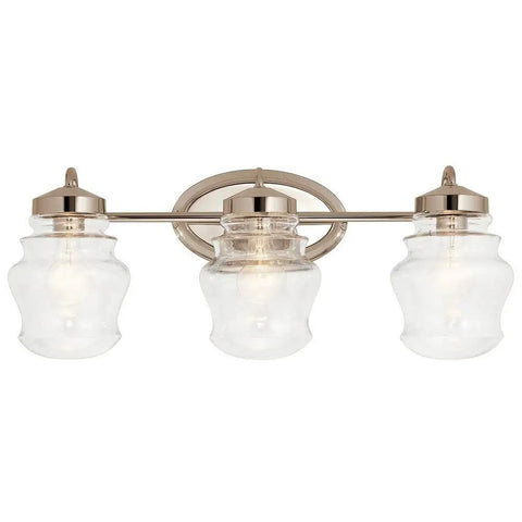 Janiel 24 Inch Three Light Vanity Light With Clear Glass Shades In Classic Bronze Finish Mounted Above Mirror