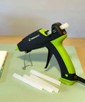 Green and black glue gun with Heavy Duty Full Size Hot Glue Sticks For Craft DIY And Repairs All Purpose Clear 4 Inch 20 Pack