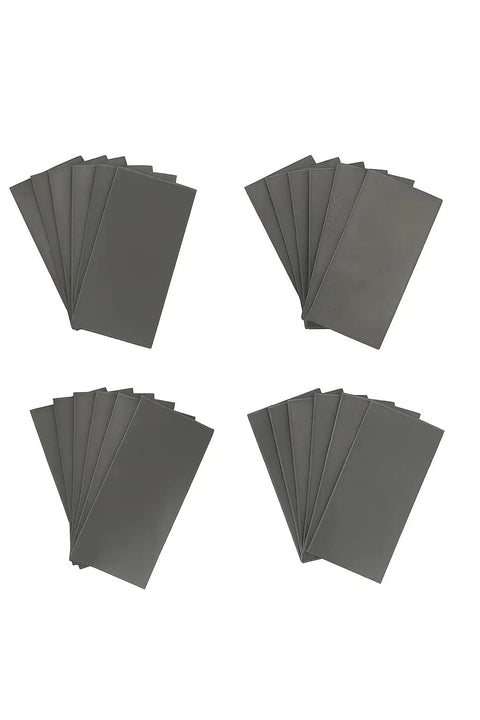 24 Piece Welding Practice Kit With 11 Gauge Mild Steel Coupons, 2 X 4 Inch, laid out in four stacks for welding practice.