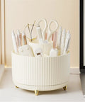 Rotating Desk Organizer With Six Compartments For Pens, Markers, Art Supplies And Makeup Tools, 360 Degree Spin Office Storage That Keeps Desk Clutter Under Control, Great For Home Office, Dorm, Nightstand Or Dresser. White plastic rotating desk organizer with six compartments and gold feet on a desk
