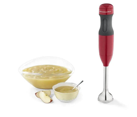 Kickass 2 Speed Hand Blender With Secure Locking Arm And Razor Sharp Stainless Steel Blade For No Sweat Puree And Soup Prep In Bold Empire Red Colorway, shown with bowls of pureed food.