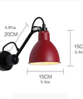 Rock Solid Plug In Swing Arm Wall Sconce With Heavy Duty Metal Reading Light Fixture Simple Toggle Switch Totally Flexible Bedside Wall Mounted Lamp Great For Bedroom Living Room size and measurements shown, featuring red metal shade and black arm.