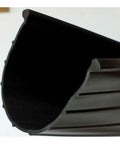 Close-up of foam-core garage door bottom seal profile for 16 ft doors, reducing drafts and moisture.