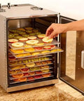 Top Tier 16 Tray Stainless Steel Food Dehydrator With Adjustable Temp Dial Electric Jerky Dryer For Legit Meat Strips Savory Dog Treats And Crisp Farm Herbs Straight From Your Pantry, filled with fruit slices.