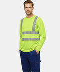 Shop Floor Ready Long Sleeve Hi Vis Safety Shirt With Bold Reflective Strips Class Three Ansi Certified Work Tee worn by model, showcasing bright yellow color.