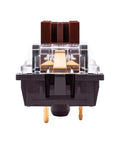 Close-up front view of a switch from the 32 Pack 3 Pin Tactile Brown Switches for Mechanical Gaming Keyboards - DIY Replacement Compatible With Cherry MX Brown and Gateron Brown, Fits MX Standard Keyboards Like Redragon MechanicalEagle E-yooso and More.