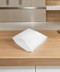 White EPE Foam Pouches Set Of 25 For Shipping Fragile Items And Glassware on a wooden countertop