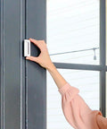 Woman installing a Door Guardian Lock And Reinforcement Kit For Inward Swing Doors Child Safety Lock For Doors 2 Pack White