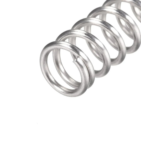 Close-up of a silver 304 stainless steel compression spring with 12mm OD and 1.6mm wire