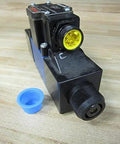 R978020569 4-way directional control valve 4WE6D62/OFEW110N9DK25L V/62 with 5-pin connector on wooden surface