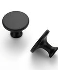 Two Sleek Matte Black Round Kitchen Cabinet Knobs from 30 Pack 1 1/4 Inch Top Notch Sleek Matte Black Round Kitchen Cabinet Knobs Zinc Solid Drawer Pulls For Cabinets Dressers Closets And Bathrooms Durable Modern Hardware For Cabinetry on white background.