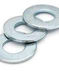 Real Deal Zinc Plated Flat Washers With One Half Inch Bore And Wide Flange Build Spreads Bolt Pressure Smoothly To Stop Pull Through On Tough Job Sites Priced Right And Sold In Thousand Piece Lots, showing three flat washers stacked.