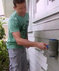 Man using Seamless Paint Roller Brush With Integrated Flocked Edger to paint exterior wall, showcasing ergonomic design and ease of use.