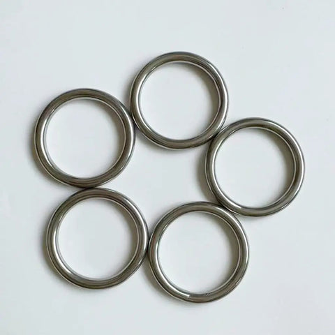 Five stainless steel O rings arranged in a circle, showcasing the Stainless Steel O Rings 5 Pack Heavy Duty Seamless Welded Closed 1.6 Inch Outer Diameter.