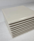 Stack of Beige Bone Almond Ceramic Bullnose Tile 4x4 Square Trim With Curved Edge 9 Piece Box Classic Color 006 for backsplash use.