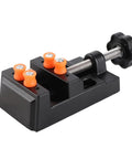 Portable Bench Vise Base With Quick Release Clamp Table For Drill Press Handling Round And Weird Shaped Pieces In Durable Black Aluminum Lightweight And Ready For No Sweat Diy Workbench Builds, compact with orange grips.