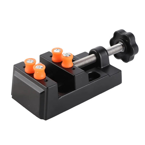 Portable Bench Vise Base With Quick Release Clamp Table For Drill Press Handling Round And Weird Shaped Pieces In Durable Black Aluminum Lightweight And Ready For No Sweat Diy Workbench Builds, compact with orange grips.