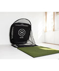 Compact Golf Practice Net 5 Foot By 5 Foot Indoor And Outdoor Hitting Net With Ball Return set up in a bright room