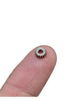 Close-up of a 0.3 Module Planetary Gearbox Gear, 5.95mm Diameter, 2.55mm Inner Hole Bore, on fingertip, 18 teeth for robotics and DIY projects.