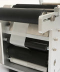 Close-up of semi auto round bottle labeling machine showing black rollers and aluminum alloy frame for precise application.