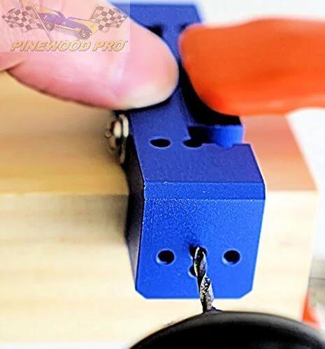 Derby Car Drill Jig for Precise Axle Holes Create Straight or 2.5 Degree Angled Holes and Raised Wheel Holes in action on wood block