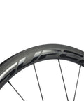 Close-up of Carbon Fiber Wheelset 38mm And 23mm Rim Depths 700c Clincher with basalt brake surface and aero spoke design.