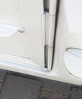 Close-up of RV door with Premium 2 Pack White Rv Door Stop Retainer Tool for Motorhomes and Travel Trailers holding door securely.