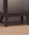 Close-up of sturdy feet on floor standing bookshelf with bamboo shelves and plastic doors, heavy duty display organizer for office or living room