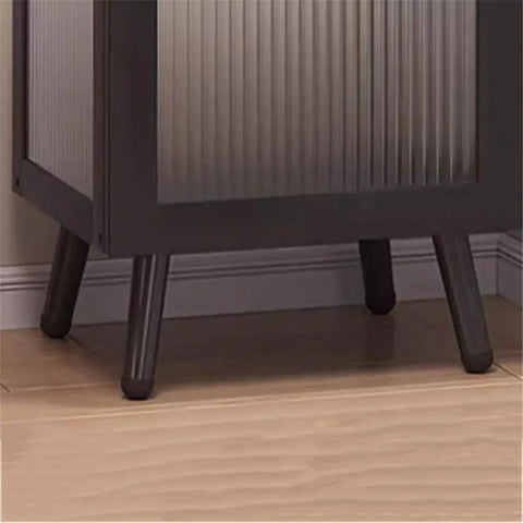 Close-up of sturdy feet on floor standing bookshelf with bamboo shelves and plastic doors, heavy duty display organizer for office or living room