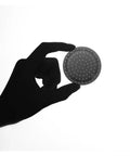 Premium Double Layer Reusable Espresso Shower Screen Filter For 51mm Portafilter held in hand with perforated surface.