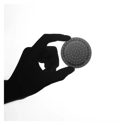Premium Double Layer Reusable Espresso Shower Screen Filter For 51mm Portafilter held in hand with perforated surface.