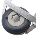 Clutch for Cam Helix, close-up view; black round automotive part with silver central spline, caliper for scale