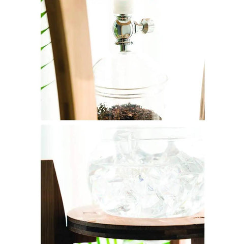 Heavy Duty Dutch Cold Brew Coffee Maker With Solid Wood Tower And Stainless Steel Filter brewing with coffee grounds and ice.