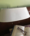 Double Headboard Bed Lamp with fabric shade clipped on headboard, book and glasses below, tool-free rubber hook attachment