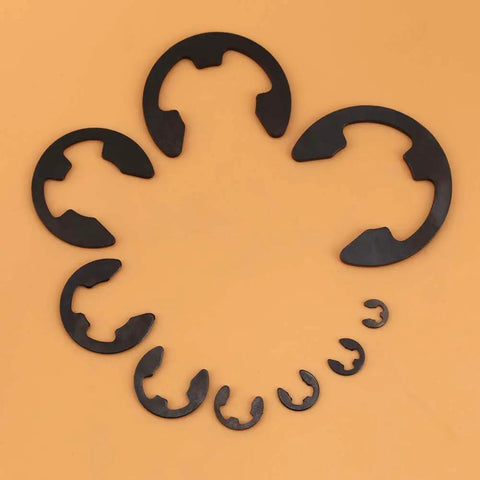 Black Metal E Clip Set For Shafts 3mm To 22mm 300 Piece Assortment Of Retaining Rings in graduated sizes on beige surface